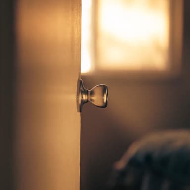 Close view of a metal bedroom door handle needing adjustment