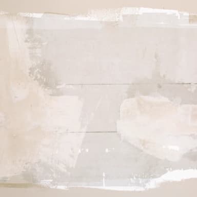 Unfinished drywall patch with visible joint compound awaiting final paint